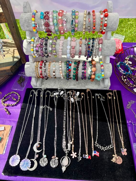 Beaded bracelets on display stands at a market table